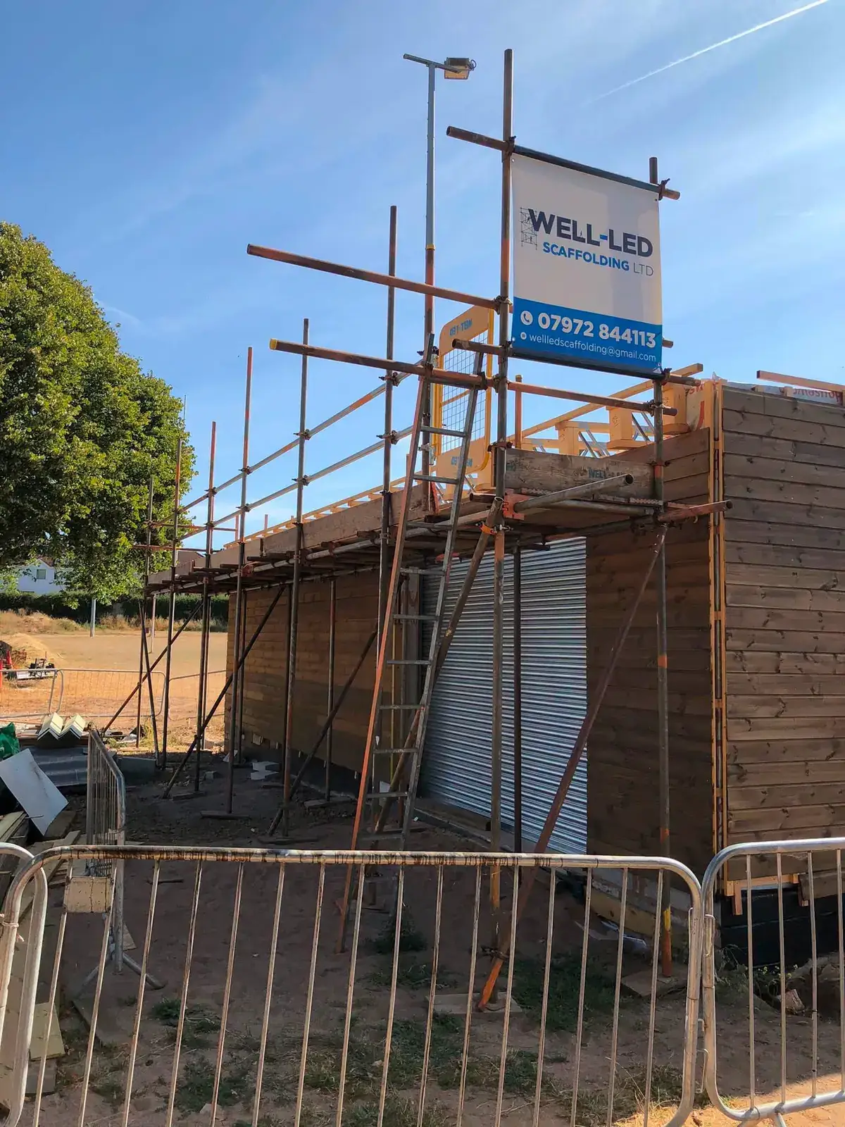 Scaffolding around a timber-framed commercial building under construction on a site in Exeter, Devon.